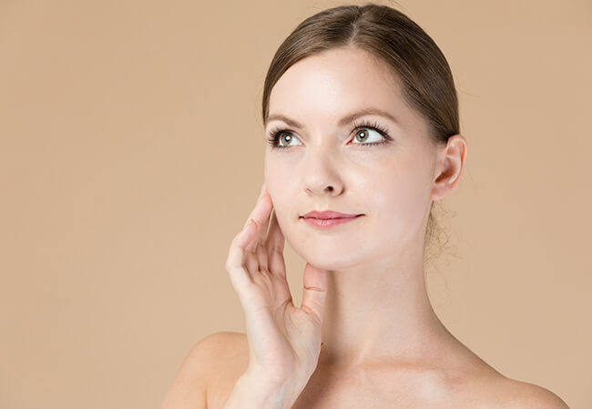 Beautiful woman with her hand on her cheek